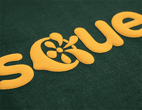 Yellow puff vinyl text with floral design on green fabric