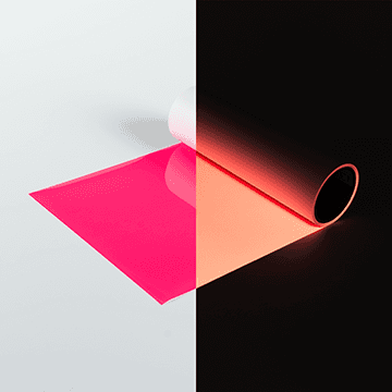 Neon pink heat transfer vinyl, half glowing in the dark